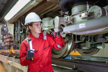 Technician Inspecting Train Suspension System