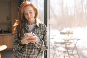 Portrait of pretty redhead young woman feeling happy using mobile phone communicate with family...
