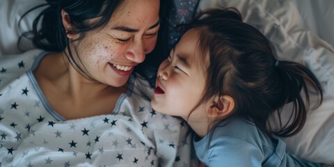 In the morning, mother and daughter kiss in bed with love, care, and happiness. Portrait of a woman...