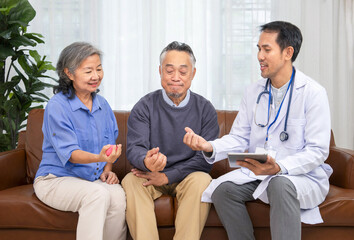 mature man physical therapist teaches asian senior couple to exercise hands and fingers with...