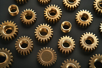 The gold gears isolated in black background. Concept of precision and engineering.