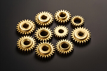 The gold gears isolated in black background. Concept of precision and engineering.