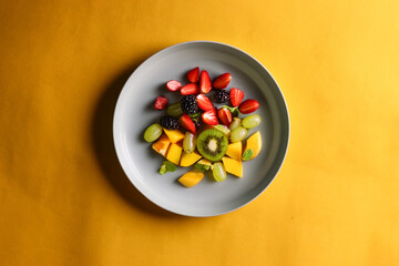 Healthy fruit salad on a white plate