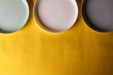 3 plates kept on a yellow background