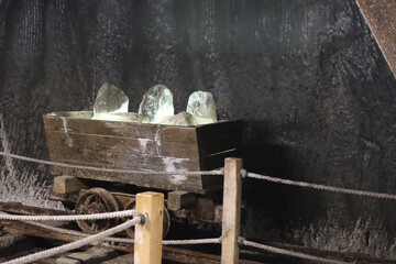 Old mine wagon with illuminated salt stones in Turda salt mine, Romania