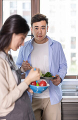 Young Oriental couple in the kitchen