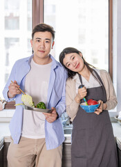 Young Oriental couple in the kitchen