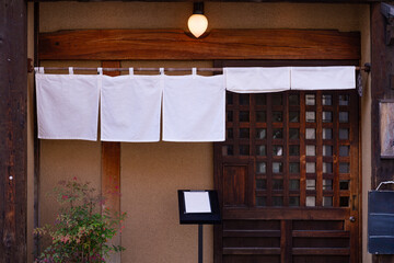 The curtain-like fabric that hangs in front of traditional Japanese restaurants and shops not only...