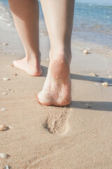 Beautiful traces with feet on sea nature background