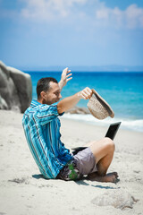 A Happy man guy with laptop near the seashore weekend travel - 799132659