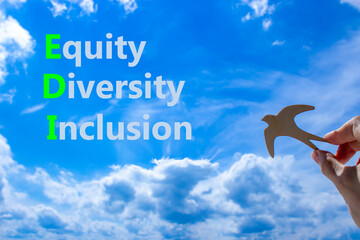 EDI equity diversity inclusion symbol. Concept words EDI equity diversity inclusion on blue sky...
