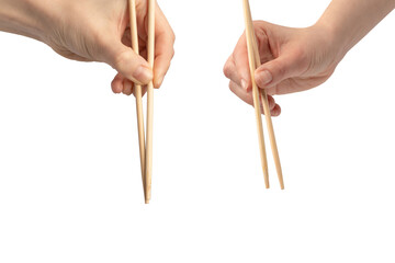 Female hand holding wooden sushi chopsticks isolated on white background.