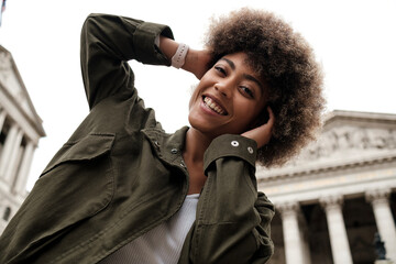 Friendly female woman posing in front of historical buildings.