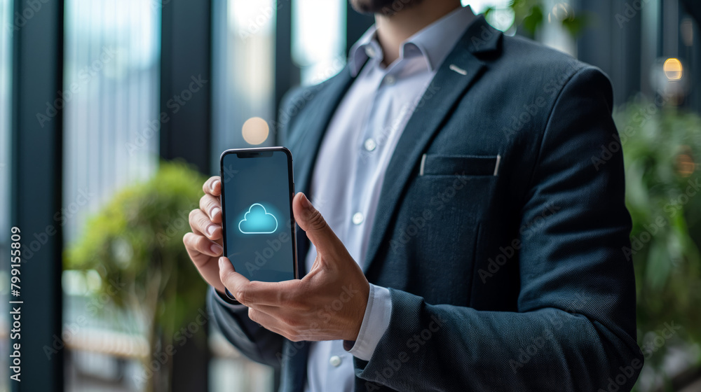 Poster close-up of a professional in a dark suit presenting a cloud icon on his smartphone, symbolizing dat