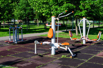 Outdoors fitness device machine in a city park for sport and activities, in a sunny spring day, in...
