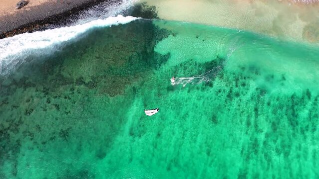 Orbiting around the Kitespot in Ponta Preta, Sal, Cape Verde while a Kiter starts below.

Remark: I have the permission of CORE Kiteboarding GmbH to sell this footage
