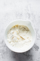 butter and flour being mixed together, butter and flour mixed into rough pastry, butter and flour being used to make cookie dough or pie dough, process of making cut out sugar cookies