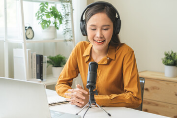 Podcast concept asian young woman radio host work with headphones, microphone while talk,...