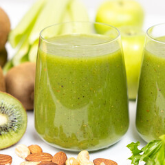 Healthy vegetable smoothie in glasses on white background.