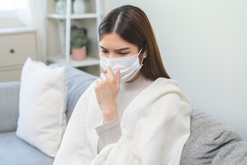 Unhealthy sickness asian young woman wearing face mask, unwell coughing, have cold, sore throat on...