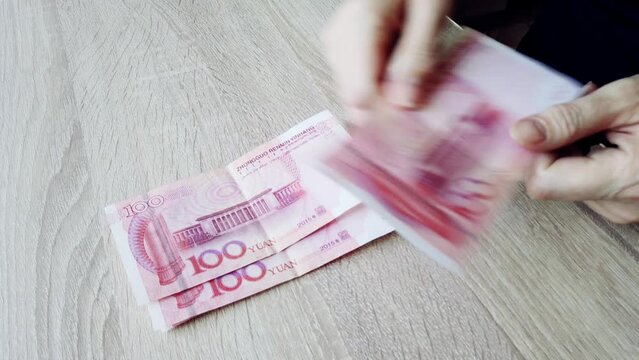 Chinese yuan cash, bankrupt counting cash. Concept of financial crisis, bankruptcy.
