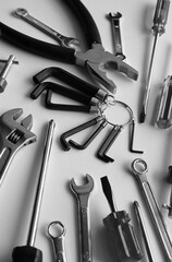 Vertical Stock Image Of Scattered Monochrome Carpentry Tools On Clean White Table 
