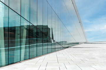 The Oslo Opera House modern glass facade and the expansive stone terrace, reflections and aesthetic in urban Norway. Perfect for travel, architecture, modernity, design articles . Copy space