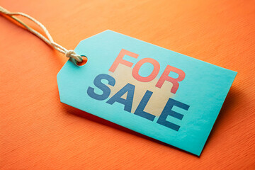 Liquidation Need in Macro of For Sale Tag on Cyan and Peach Background
