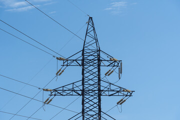 Electricity transmission towers and power lines in blue sky. Detail high voltage pole. Energy...