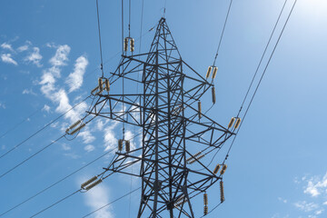 Electricity transmission towers and power lines in blue sky. Detail high voltage pole. Energy...
