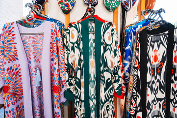 Traditional Arab Uzbek dresses with colored pattern at the oriental bazaar in Uzbekistan in Tashkent