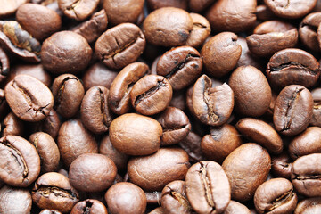 Roasted coffee beans close up background