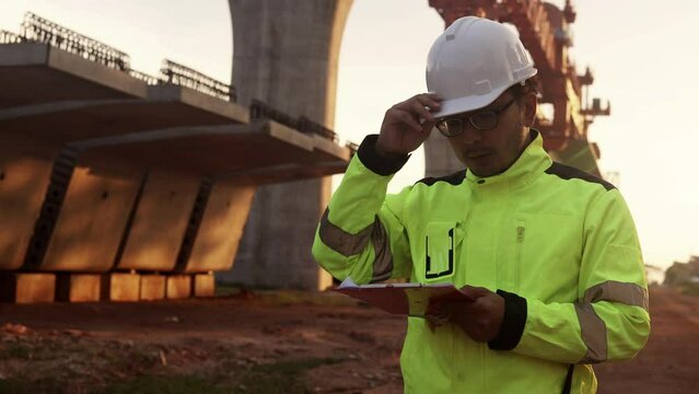 Asian engineer working at site of a large building project,Thailand people,Work overtime at construction site