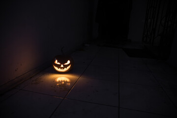 Halloween horror concept with glowing pumpkin. Halloween evil pumkins smilin faces in dark .
