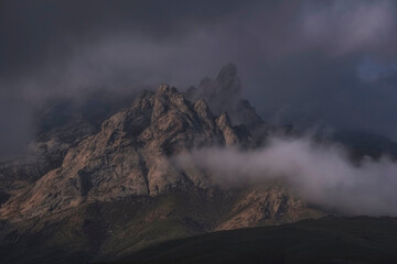 Misty, mystical and spiky dolomite mountains after a thunderstorm, Kelinshektau mountains in the Karatau massif in Kazakhstan