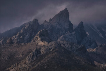 Misty, mystical, peaked dolomite mountains after a thunderstorm, Kelinshektau mountains in the Karatau massif in Kazakhstan