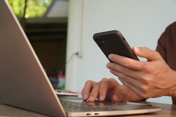 Portrait of Asian male manager working using laptop computer in modern office Male employee sitting at office and using PC See the keyboard typing screen. Enjoy working remotely