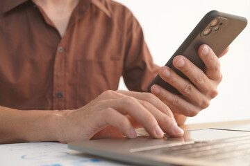 Portrait of Asian male manager working using laptop computer in modern office Male employee sitting at office and using PC See the keyboard typing screen. Enjoy working remotely