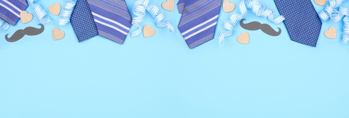 Fathers Day top border of gifts, decor, ties and ribbon. Above view on a blue banner background....