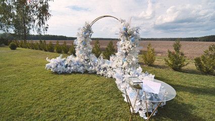 White wedding arch with chairs before the ceremony.