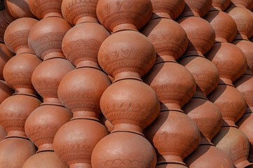 Earthen mud pots made for water storage newly made and stack one above for drying in the sunlight....