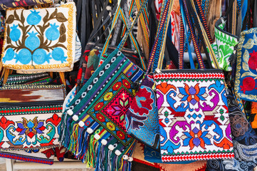 fabric bags with a traditional bright colorful Asian pattern at the oriental bazaar in Uzbekistan...