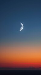 The crescent moon hangs in the sky, casting a silvery glow on the horizon
