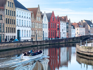 Tourist boat on canal in Bruges in a beautiful summer day, Belgium - obrazy, fototapety, plakaty