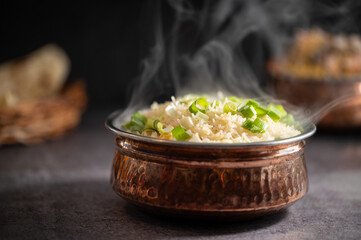 Smoky white rice. Prepared and served in a brass bowl