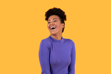 Woman Laughing in Front of Yellow Background