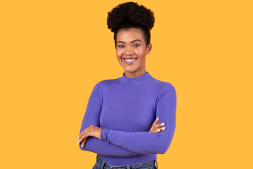 Smiling Woman With Crossed Arms Posing On Yellow