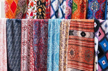 Traditional Indian scarves with a colorful pattern at an Asian bazaar in India close-up