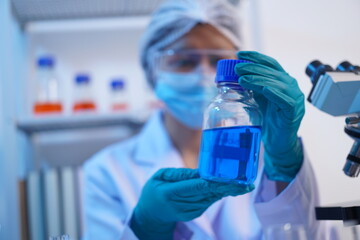 Science test tubes, laboratory equipment for new medical research, microbiology research with small pipettes in close-up. Asian and African female scientists in the laboratory, perfume samples