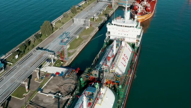 Aerial view ship LPG tankers vessel loading in gas and oil terminal station refinery, Global trading import export logistic transport sea freight Liquefied Petroleum Gas tanker